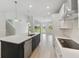 Stylish kitchen featuring white cabinets, stainless steel appliances, and a spacious center island at 6074 Sacred Oak Ave, Mount Dora, FL 32757