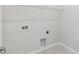 Bright laundry room featuring tile floors, utility connections, and upper wire shelving for optimal storage at 6074 Sacred Oak Ave, Mount Dora, FL 32757