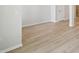 Spacious room with light wood flooring, white walls, and baseboards creating a clean, minimalist design at 6074 Sacred Oak Ave, Mount Dora, FL 32757