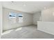 Loft area with neutral paint, carpet flooring, and natural light from two windows at 6074 Sacred Oak Ave, Mount Dora, FL 32757