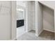 Spacious walk-in closet with wire shelving and carpet flooring with view into bathroom at 6074 Sacred Oak Ave, Mount Dora, FL 32757