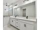 Modern bathroom with double vanity, black matte fixtures, and a walk-in shower at 5938 Bristle Oak St, Mount Dora, FL 32757