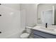 Clean bathroom with a shower-tub combo, modern fixtures, and white subway tile at 5938 Bristle Oak St, Mount Dora, FL 32757