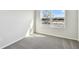 Well-lit bedroom featuring carpet flooring and a large window at 5938 Bristle Oak St, Mount Dora, FL 32757