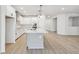 Modern kitchen with gray island and white cabinets at 5938 Bristle Oak St, Mount Dora, FL 32757