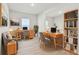 Well-lit home office with two desks, a chair, a bookcase and a large window at 5938 Bristle Oak St, Mount Dora, FL 32757