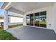 Covered patio with sliding glass doors leading to the backyard at 5938 Bristle Oak St, Mount Dora, FL 32757