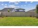 Spacious backyard with lush grass, bordered by a tall privacy fence, ideal for recreation and relaxation at 6063 Sacred Oak Ave, Mount Dora, FL 32757