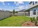 Private fenced backyard with green lawn and landscaping, ready for outdoor activities and relaxation at 6063 Sacred Oak Ave, Mount Dora, FL 32757