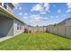 Well-maintained backyard featuring a lush lawn and a privacy fence, perfect for outdoor enjoyment at 6063 Sacred Oak Ave, Mount Dora, FL 32757