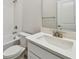 Bathroom with tiled tub-shower, toilet, and vanity with quartz countertop at 6063 Sacred Oak Ave, Mount Dora, FL 32757