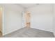 Carpeted bedroom with open doorway and closet, plus one window at 6063 Sacred Oak Ave, Mount Dora, FL 32757