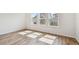 Bright bedroom with sunlight streaming in through the windows and wood floor at 6063 Sacred Oak Ave, Mount Dora, FL 32757