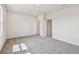 Spacious bedroom showing carpeted floors and two doorways at 6063 Sacred Oak Ave, Mount Dora, FL 32757
