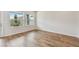 Bright bedroom with wood flooring, two windows and white walls at 6063 Sacred Oak Ave, Mount Dora, FL 32757