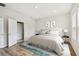 Calm primary bedroom with a king-sized bed, wood floors, and ensuite bathroom at 6063 Sacred Oak Ave, Mount Dora, FL 32757