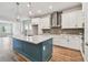 Stylish kitchen featuring an island with bar seating, white cabinets, stainless steel appliances, and modern pendant lights at 6063 Sacred Oak Ave, Mount Dora, FL 32757