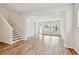 Open-concept living room with wood floors, recessed lighting, and a staircase at 6063 Sacred Oak Ave, Mount Dora, FL 32757