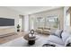Comfortable living room featuring modern decor, neutral tones, and ample natural light at 6063 Sacred Oak Ave, Mount Dora, FL 32757