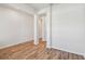 Spacious living room with wood flooring, white walls, and view to the hallway at 6063 Sacred Oak Ave, Mount Dora, FL 32757