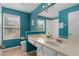 Bathroom with teal walls and updated vanity at 13438 Davenham Pt, Orlando, FL 32832