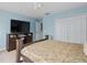 Spacious bedroom with large TV, ample closet space, and carpeted floor at 13438 Davenham Pt, Orlando, FL 32832