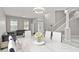 Bright dining room with white table and chairs, adjacent to living room at 13438 Davenham Pt, Orlando, FL 32832