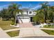 Two-story house with a white garage door and palm trees in the front yard at 13438 Davenham Pt, Orlando, FL 32832