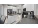 Modern kitchen with white cabinets, granite countertops and stainless steel appliances at 13438 Davenham Pt, Orlando, FL 32832