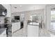 Modern kitchen featuring white cabinets, granite countertops, and stainless steel appliances at 13438 Davenham Pt, Orlando, FL 32832