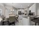 Modern kitchen with white cabinets, granite countertops, and breakfast bar at 13438 Davenham Pt, Orlando, FL 32832
