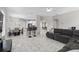 Open living space with gray sectional sofa, tile floors, and kitchen views at 13438 Davenham Pt, Orlando, FL 32832