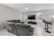 Living room with sectional sofa and access to kitchen at 13438 Davenham Pt, Orlando, FL 32832