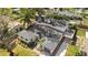 Aerial view of a home with a black roof, nice lawn, and long driveway at 3203 S Polk Ave, Lakeland, FL 33803