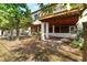 Exterior view highlighting the home's elevated deck and outdoor patio with views of the landscaped yard at 3203 S Polk Ave, Lakeland, FL 33803