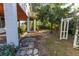 Backyard showcasing the home's foundation, lush greenery, and mature trees at 3203 S Polk Ave, Lakeland, FL 33803