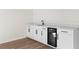 Bar area with beverage cooler and white cabinets at 3203 S Polk Ave, Lakeland, FL 33803