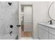 Well-lit bathroom with white marble tiles, shower and modern finishes at 3203 S Polk Ave, Lakeland, FL 33803