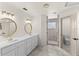 Bathroom with dual vanities, tiled floors and a large shower at 3203 S Polk Ave, Lakeland, FL 33803