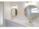 Elegant bathroom vanity with double sinks, gold fixtures and bright lighting at 3203 S Polk Ave, Lakeland, FL 33803