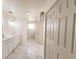 Bright bathroom featuring a tiled walk-in shower, double vanity and neutral color palette at 3203 S Polk Ave, Lakeland, FL 33803