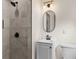 Nicely remodeled bathroom with new vanity, oval mirror and tiled shower at 3203 S Polk Ave, Lakeland, FL 33803