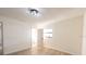 Bedroom with light wood floors and doorway into the bathroom at 3203 S Polk Ave, Lakeland, FL 33803