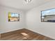 Bright bedroom featuring modern vinyl floors and two large windows at 3203 S Polk Ave, Lakeland, FL 33803
