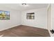 Bright bedroom featuring modern vinyl floors, neutral paint and a flush mount light fixture at 3203 S Polk Ave, Lakeland, FL 33803