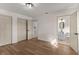 Bedroom features wood floors and a glimpse into the en-suite bathroom at 3203 S Polk Ave, Lakeland, FL 33803
