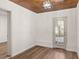 Bright bedroom has hardwood floors, a wooden ceiling, and a door to the outside at 3203 S Polk Ave, Lakeland, FL 33803
