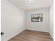 Clean bedroom with wood floors and a view of a tree outside the window at 3203 S Polk Ave, Lakeland, FL 33803