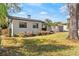 An exterior view of a charming home, with a detached garage and well-maintained lawn at 3203 S Polk Ave, Lakeland, FL 33803