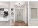 Foyer has white walls, hardwood floors, and a modern light fixture at 3203 S Polk Ave, Lakeland, FL 33803